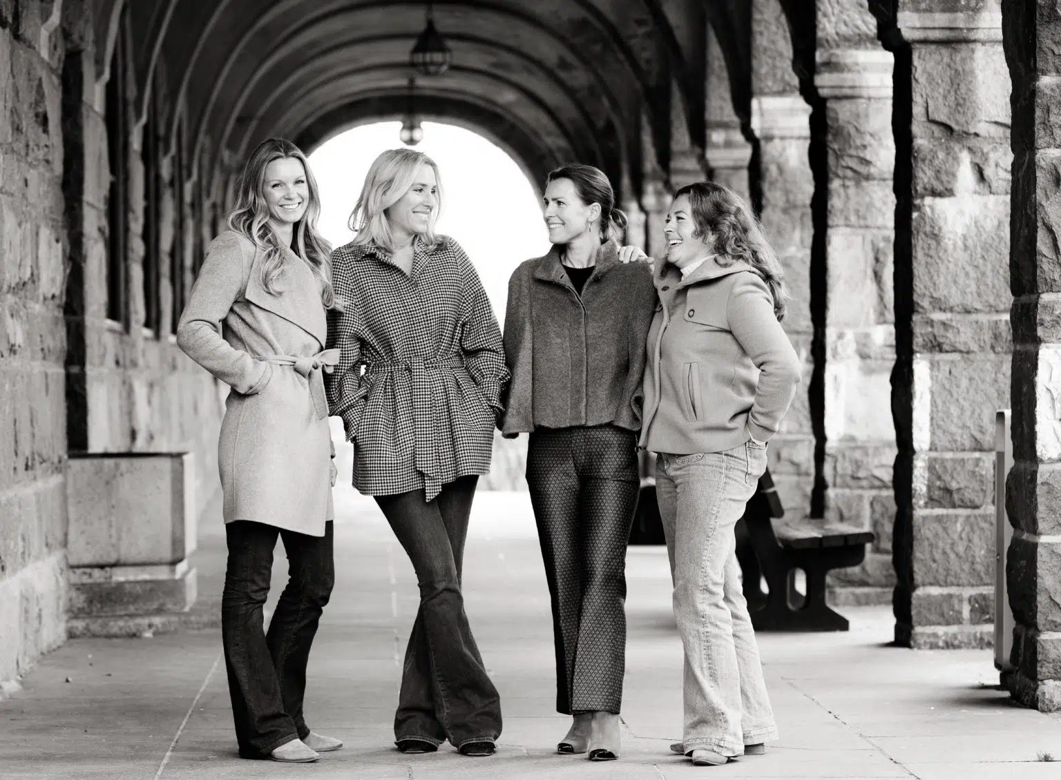 The four women of Colline Design beneath a stone arcade